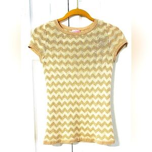 Gold and Cream colored, short-sleeve, knit top, with a Chevron pattern.
